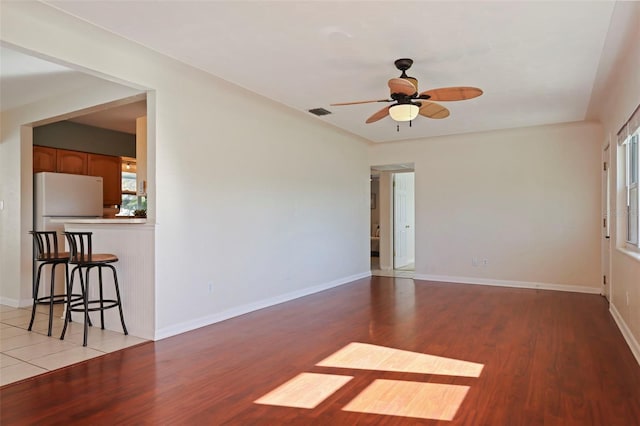 empty room with wood-type flooring and ceiling fan