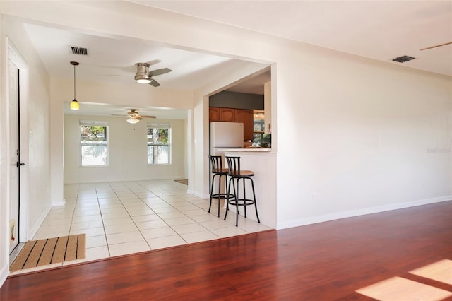 interior space with light wood-type flooring and ceiling fan