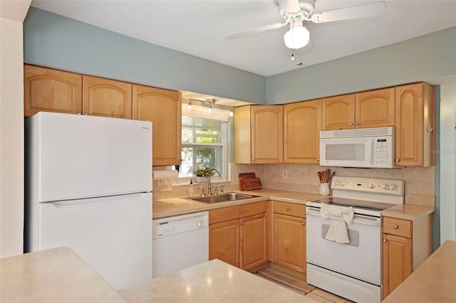 kitchen with light brown cabinets, white appliances, sink, and tasteful backsplash