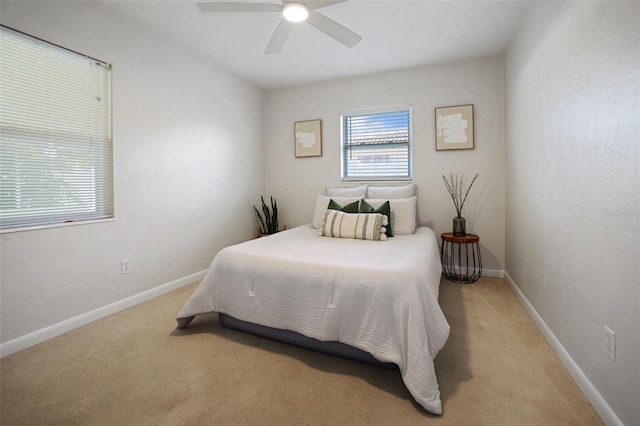 bedroom featuring ceiling fan and light colored carpet