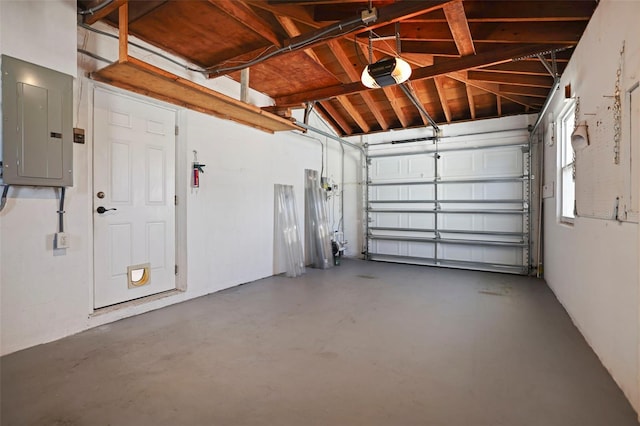 garage featuring electric panel and a garage door opener