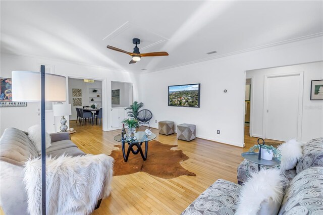 living room with ceiling fan, light hardwood / wood-style floors, and crown molding