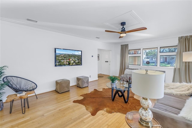 living room featuring ceiling fan, light hardwood / wood-style flooring, and ornamental molding