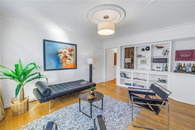 living room featuring hardwood / wood-style floors and ornamental molding