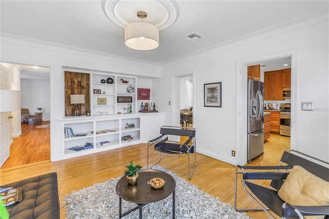 living room with light hardwood / wood-style floors and crown molding