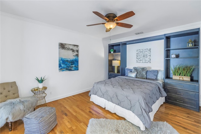 bedroom with wood-type flooring, ceiling fan, and ornamental molding