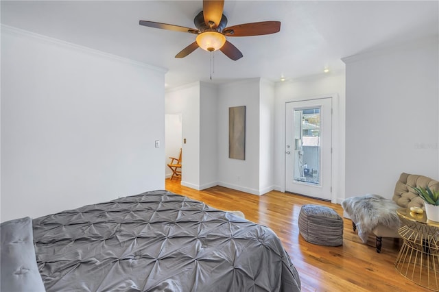 bedroom with access to outside, ceiling fan, hardwood / wood-style floors, and ornamental molding