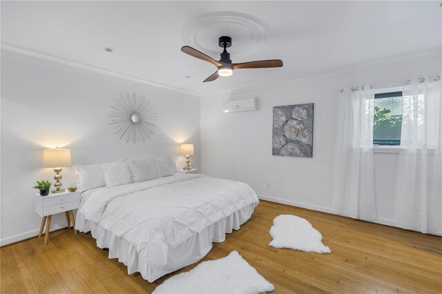 bedroom with hardwood / wood-style floors, ceiling fan, crown molding, and a wall mounted AC