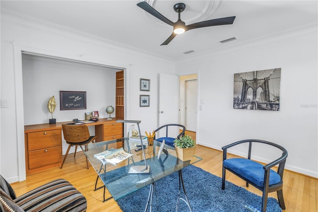 living room with ceiling fan, light wood-type flooring, and ornamental molding