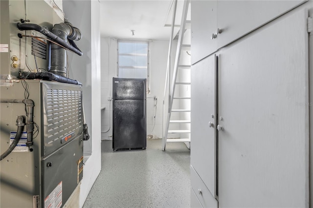 utility room featuring heating unit