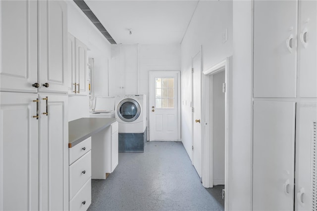 clothes washing area with cabinets and washer / clothes dryer