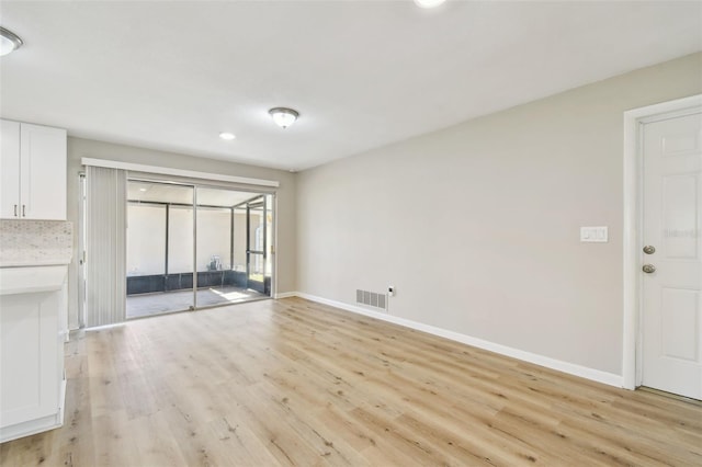 unfurnished living room with light wood-type flooring