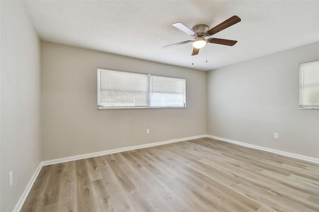 unfurnished room with ceiling fan, light hardwood / wood-style flooring, and a textured ceiling