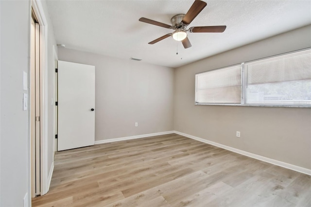 spare room featuring ceiling fan and light wood-type flooring