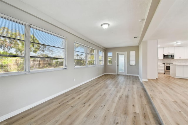 unfurnished living room with light wood-type flooring