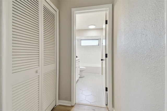 hallway featuring light tile patterned floors