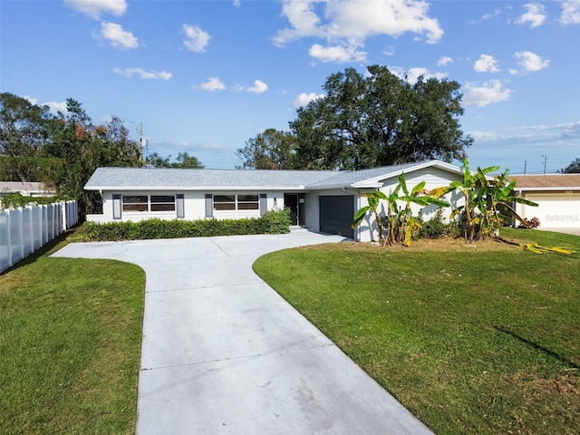 single story home with a garage and a front lawn