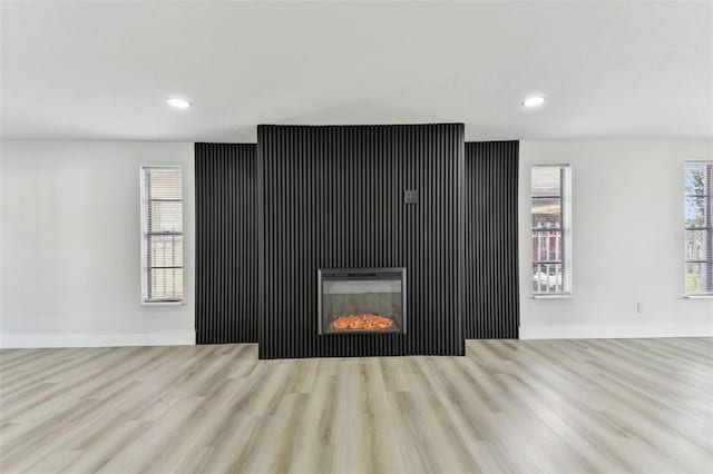 unfurnished living room featuring light wood-type flooring