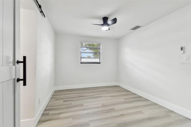 spare room with light wood-type flooring and ceiling fan