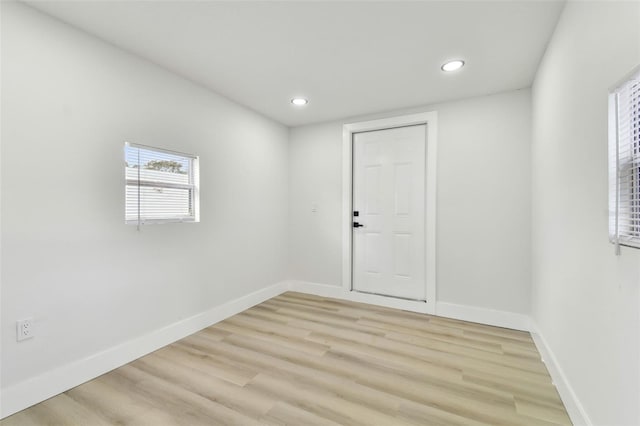 unfurnished room with light wood-type flooring