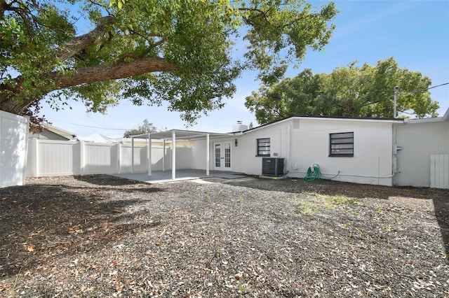 back of house featuring french doors and central air condition unit