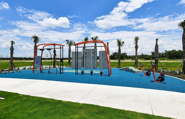 view of jungle gym featuring a yard and a water view