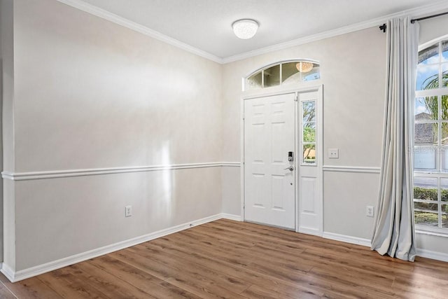 foyer with hardwood / wood-style flooring and ornamental molding