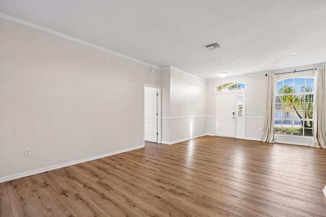 unfurnished room featuring crown molding and wood-type flooring