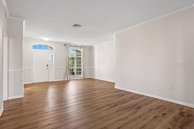 foyer featuring dark hardwood / wood-style floors and ornamental molding