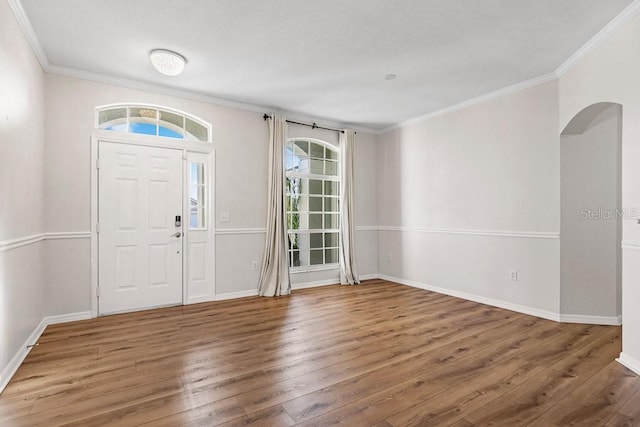 entryway with dark hardwood / wood-style floors and ornamental molding