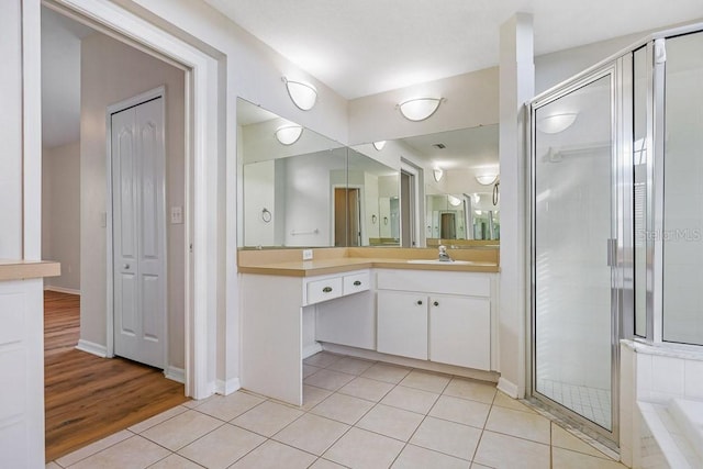 bathroom featuring tile patterned floors, vanity, and independent shower and bath