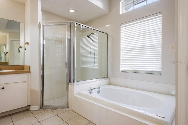 bathroom with tile patterned floors, vanity, and plus walk in shower