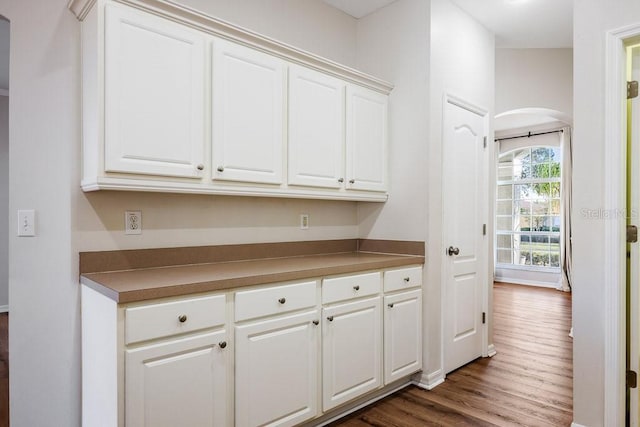 kitchen featuring dark hardwood / wood-style flooring and white cabinetry