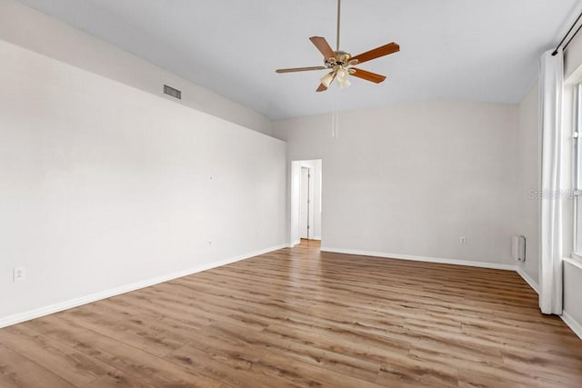 unfurnished room with light hardwood / wood-style floors, ceiling fan, and lofted ceiling