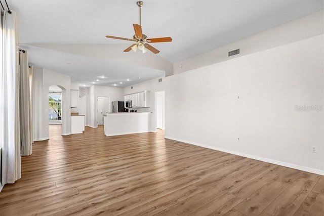 unfurnished living room featuring wood-type flooring, ceiling fan, and lofted ceiling