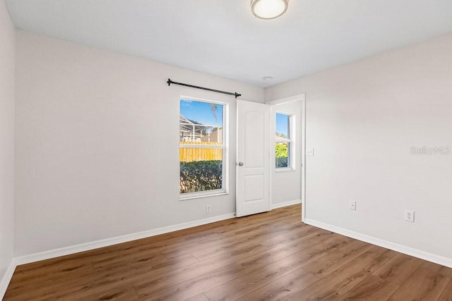 spare room with hardwood / wood-style floors