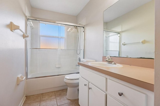 full bathroom featuring tile patterned floors, toilet, vanity, and combined bath / shower with glass door