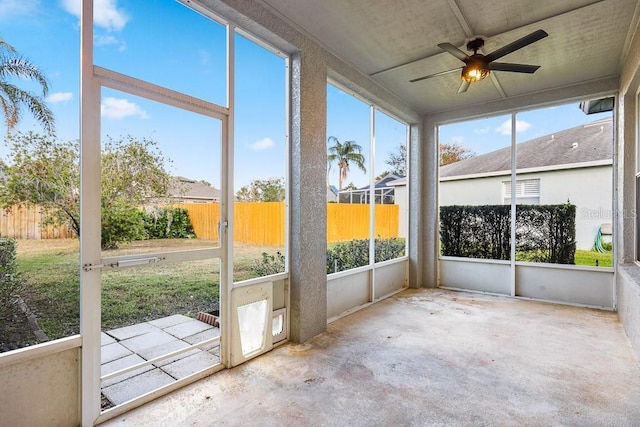 unfurnished sunroom featuring ceiling fan