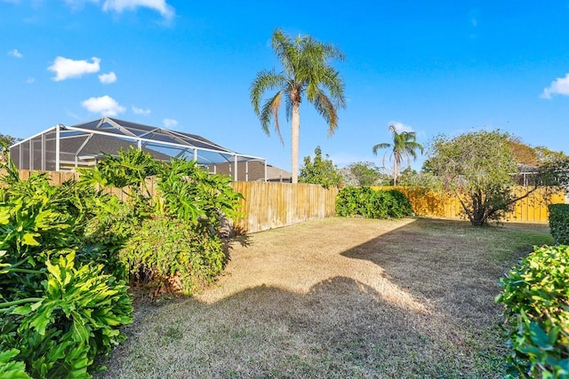 view of yard featuring glass enclosure