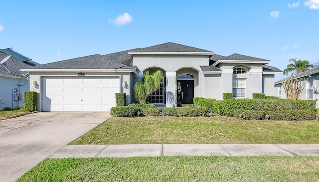 view of front of home with a front yard and a garage