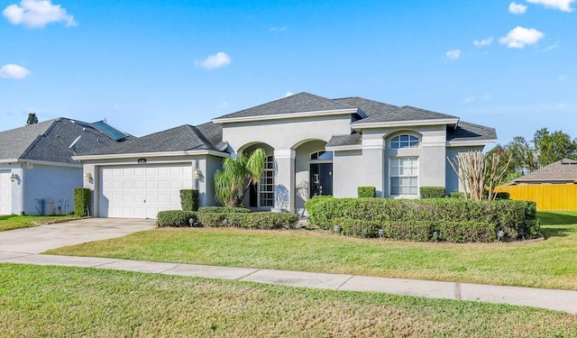 view of front of property featuring a front yard and a garage