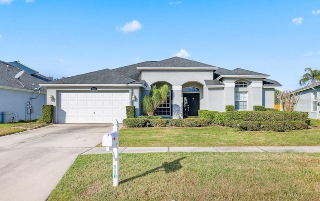 view of front of house with a garage and a front lawn