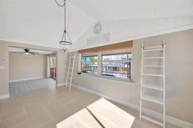 tiled spare room with ceiling fan with notable chandelier and vaulted ceiling