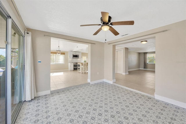 spare room with plenty of natural light and ceiling fan