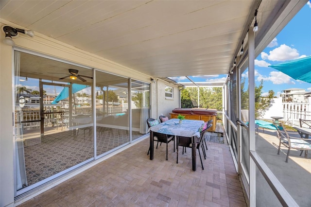 sunroom / solarium featuring ceiling fan