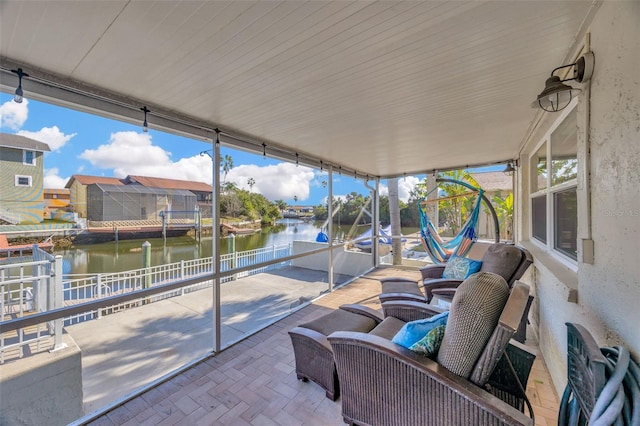 sunroom / solarium with a water view