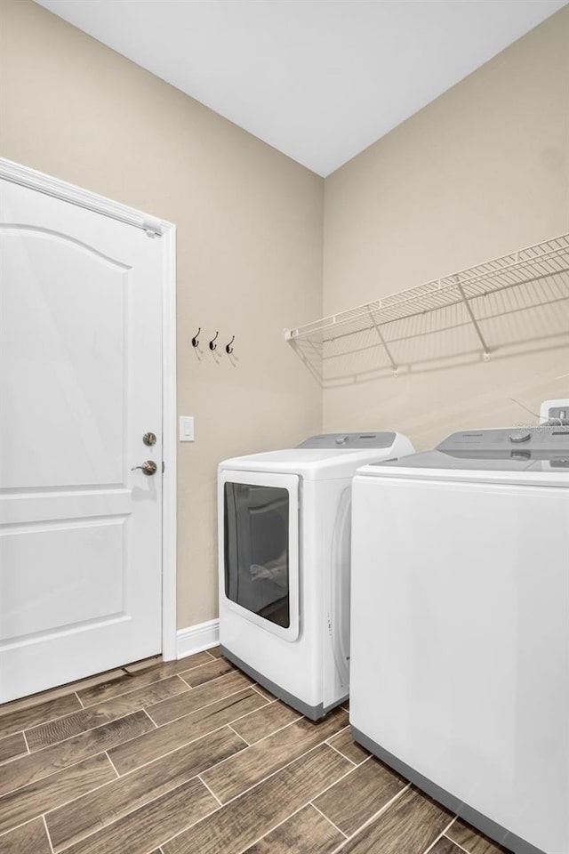 washroom featuring washer and clothes dryer and dark wood-type flooring