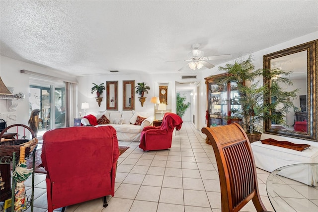 living room with light tile patterned floors, a textured ceiling, and ceiling fan