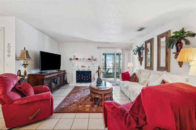 living room with light tile patterned flooring and a textured ceiling