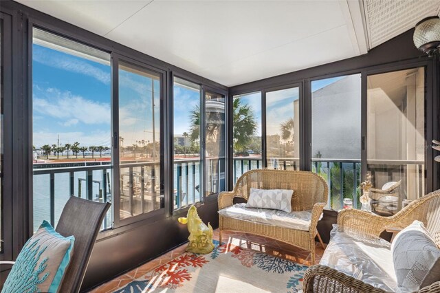 sunroom / solarium with plenty of natural light and a water view